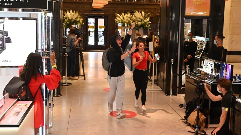 The first customers react as they are filmed entering Selfridges department store