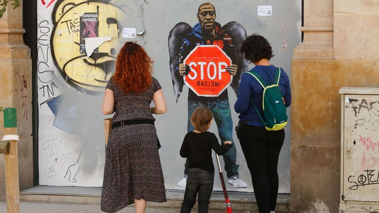 A street poster artwork by Italian urban artist Salvatore Benintende aka &#39;TVBOY&#39; depicting George Floyd with angel wings in a street in Barcelona