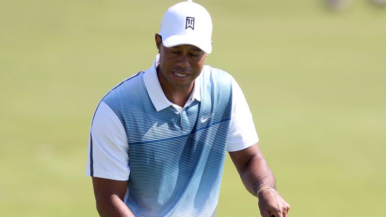 US golfer Tiger Woods reacts to missing a putt on the 8th green during his first round 69, on the opening day of the 2014 British Open Golf Championship at Royal Liverpool Golf Course in Hoylake, north west England on July 17, 2014. Woods, 18 months shy of his 40th birthday, says that for the first time in years he is pain free and ready to go as he once again hones in on his lifelong obsession of matching and finally surpassing the all-time major record of 18 wins held by Jack Nicklaus since 19