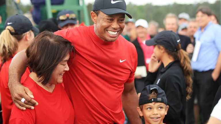 AUGUSTA, GEORGIA - APRIL 14: Tiger Woods of the United States  celebrates with his son Charlie Axel as he comes off the 18th hole in honor of his win during the final round of the Masters at Augusta National Golf Club on April 14, 2019 in Augusta, Georgia. (Photo by Andrew Redington/Getty Images)