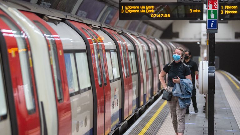 A commuter wearing a protective face mask at Clapham Common underground station