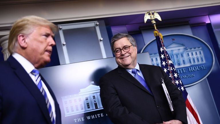 US President Donald Trump arrives as Attorney General William Barr looks on during the daily briefing on the novel coronavirus, COVID-19, at the White House on March 23, 2020, in Washington, DC. (Photo by Brendan Smialowski / AFP) (Photo by BRENDAN SMIALOWSKI/AFP via Getty Images)
