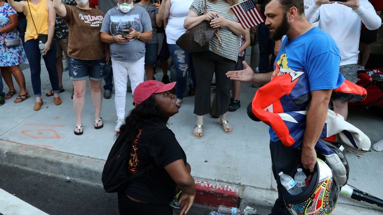 A demonstrator (front L) argues with a supporter of U.S. President Donald Trump outside the venue for Trump&#39;s rally in Tulsa, Oklahoma, U.S., June 20, 2020