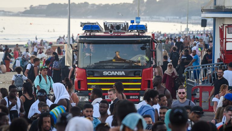 BOURNEMOUTH, ENGLAND - JUNE 25: A fire engine struggles through the crowds on the promenade on June 25, 2020 in Bournemouth, United Kingdom. A major incident was declared by the local council as thousands flocked to Bournemouth and the Dorset coast. The UK is experiencing a summer heatwave, with temperatures in many parts of the country expected to rise above 30C and weather warnings in place for thunderstorms at the end of the week. (Photo by Finnbarr Webster/Getty Images)