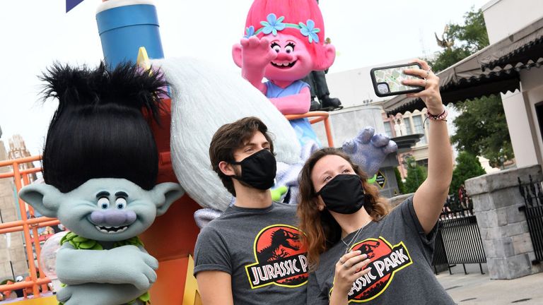 ORLANDO, FLORIDA - JUNE 05: Visitors take a selfie at Universal Studios theme park on the first day of reopening from the coronavirus pandemic, on June 05, 2020 in Orlando, Florida. (Photo by Gerardo Mora/Getty Images,)