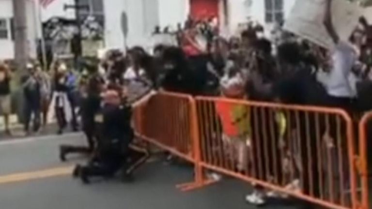 A crowd cheered in Hightstown, in central New Jersey, on Tuesday, June 2, when a group of police officers kneeled with demonstrators during a Black Lives Matter rally.