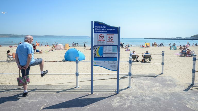 Visitors enjoy the hot weather on the beach in Weymouth