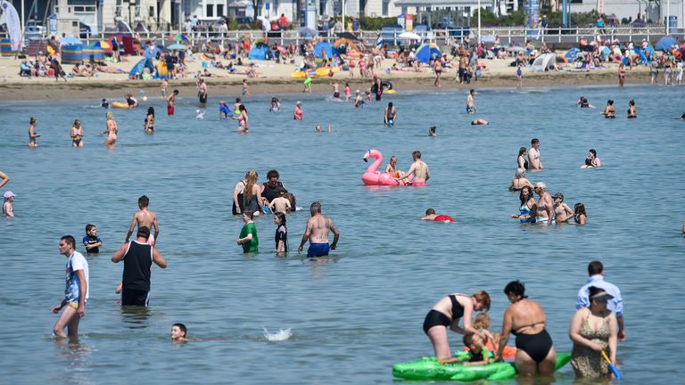 People swimming in the sea in Weymouth as UK temperatures soar