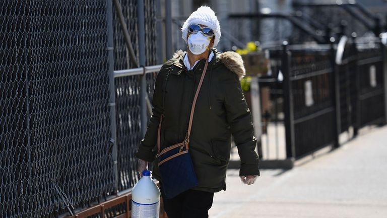 A person with a face mask carries a gallon of bleach on April 07, 2020 in Brooklyn, New York. (Photo by Angela Weiss / AFP) (Photo by ANGELA WEISS/AFP via Getty Images)
