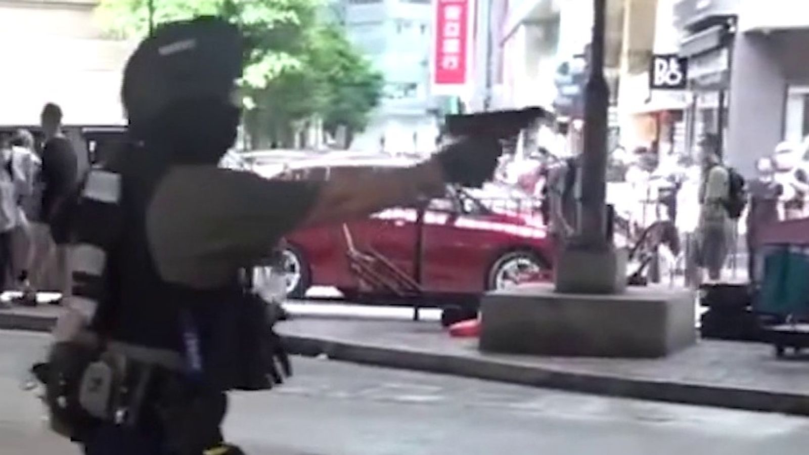 Officer pulls gun on Hong Kong protesters