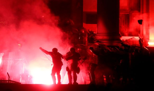 Serbia: Police fire tear gas as protesters try to storm Belgrade parliament building