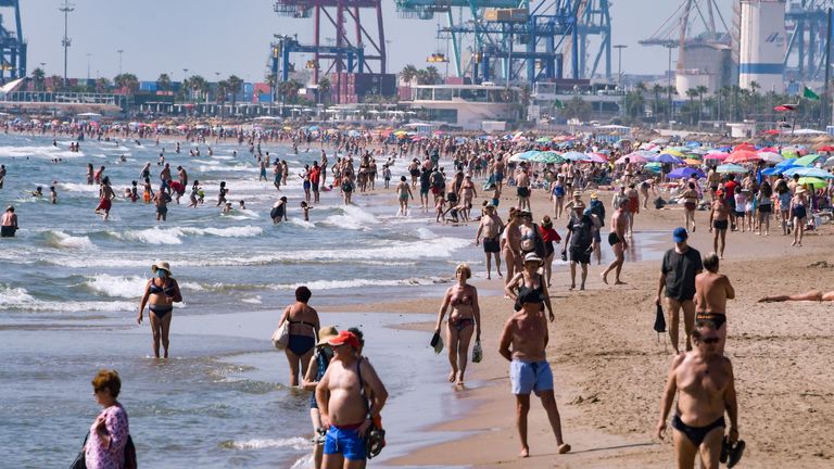 People sunbathe at La Malvarrosa beach in Valencia July 01,2020. - The European Union reopened its borders to visitors from 15 countries but excluded the United States, where coronavirus deaths are spiking once again, six months after the first cluster was reported in China. (Photo by JOSE JORDAN / AFP) (Photo by JOSE JORDAN/AFP via Getty Images)