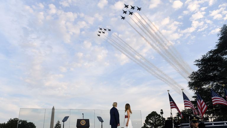 US President Donald Trump and First Lady Melania Trump watch as Thunderbirds and Blue Angels aircrafts flyover during the 2020 "Salute to America" event in honor of Independence Day on the South Lawn of the White House in Washington, DC, July 4, 2020. (Photo by SAUL LOEB / AFP) (Photo by SAUL LOEB/AFP via Getty Images)