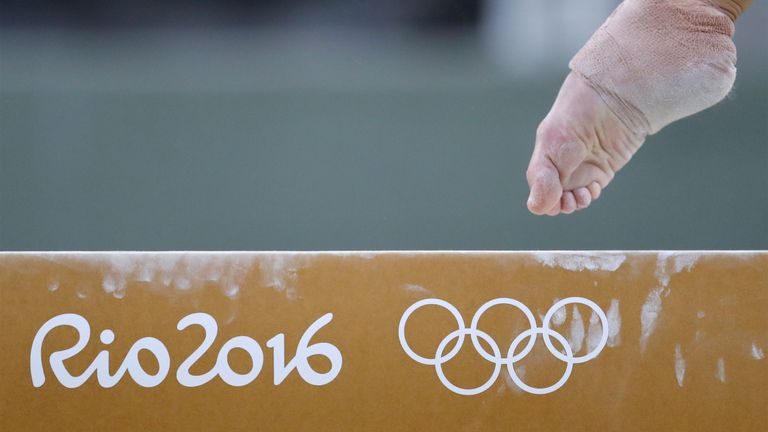 TOPSHOT - A gymnast practices on the balance beam of the women's Artistic gymnastics on August 4, 2016 ahead of the Rio 2016 Olympic Games in Rio de Janeiro. / AFP / Thomas COEX        (Photo credit should read THOMAS COEX/AFP via Getty Images)