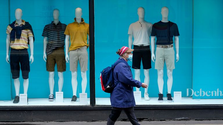 MANCHESTER, UNITED KINGDOM - JULY 02: A shopper wearing a face mask walks past a Debenhams store on July 02, 2020 in Manchester, United Kingdom. Many more retailers are reopening with social distancing measures after being shuttered for months due to the Covid-19 pandemic. Pubs and restaurants can fully reopen in England from July 4th. (Photo by Christopher Furlong/Getty Images)