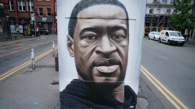 MANCHESTER, UNITED KINGDOM - JUNE 03: Floral tributes lay next to a mural of George Floyd, by street artist Akse, in Manchester's northern quarter on June 03, 2020 in Manchester, United Kingdom. The death of an African-American man, George Floyd, while in the custody of Minneapolis police has sparked protests across the United States, as well as demonstrations of solidarity in many countries around the world. (Photo by Christopher Furlong/Getty Images)