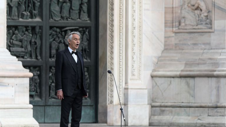 Italian tenor and opera singer Andrea Bocelli sings during a rehearsal on a deserted Piazza del Duomo in central Milan on April 12, 2020, prior to an evening performance without public for the world wounded by the pandemic, during the country's lockdown aimed at curbing the spread of the COVID-19 infection, caused by the novel coronavirus. (Photo by Piero Cruciatti / AFP) (Photo by PIERO CRUCIATTI/AFP via Getty Images)