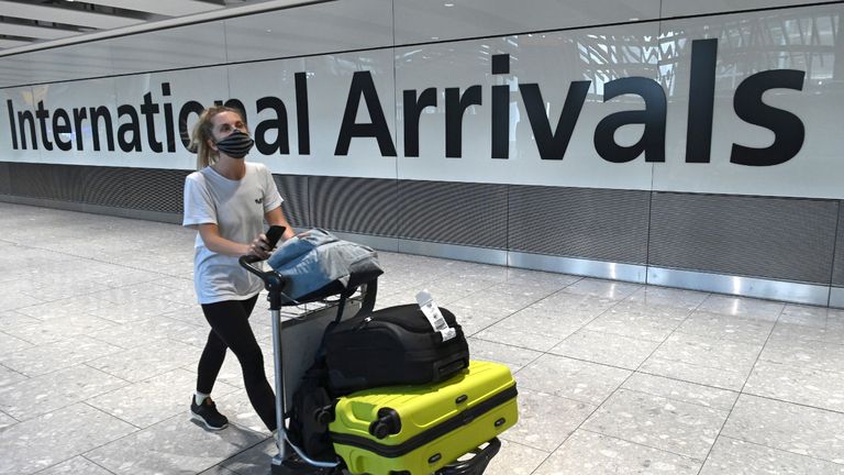 Passengers wearing a face mask or covering due to the COVID-19 pandemic, arrive at Heathrow airport, west London, on July 10, 2020. - The British government on Friday revealed the first exemptions from its coronavirus quarantine, with arrivals from Germany, France, Spain and Italy no longer required to self-isolate from July 10. Since June 8, it has required all overseas arrivals -- including UK residents -- to self-quarantine to avoid the risk of importing new cases from abroad. (Photo by DANIEL LEAL-OLIVAS / AFP) (Photo by DANIEL LEAL-OLIVAS/AFP via Getty Images)