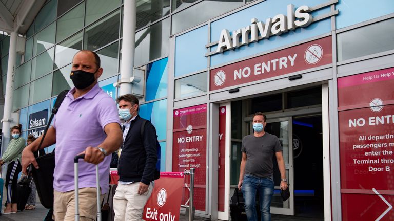 Passengers flying from Malaga arrive at Birmingham Airport, following an announcement on Saturday that holidaymakers who had not returned from Spain and its islands by midnight would be forced to quarantine for 14 days after Covid-19 second wave fears saw the European country struck off the UK's safe list. The decision was made after Spain recorded more than 900 fresh daily Covid-19 cases for two days running.