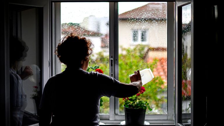 BURGOS, SPAIN - APRIL 18: Rafaela Pérez waters the plants in a window of her house, She is an old widowed woman who has lived alone for a year on April 18, 2020 in Burgos, Spain. Spain is beginning to ease strict lockdown measures to ease its economy, people in some services including manufacturing, construction are being allowed to return to work but must adhere to strict safety guidelines. More than 17,000 people are reported to have died in Spain due to the COVID-19 outbreak, although the country has reported a decline in the daily number of deaths. (Photo by Samuel de Roman/Getty Images)