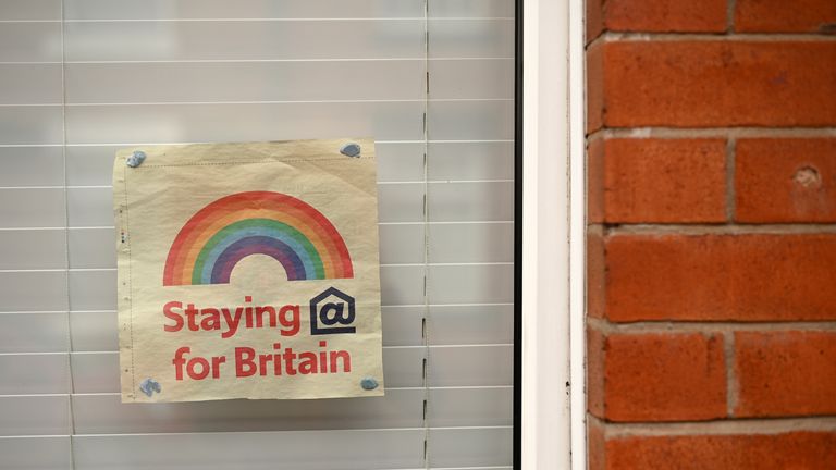A poster depicting the colours of a rainbow, being used as symbols of hope during the COVID-19 pandemic, is pictured in the window of a house in Manchester, north west England, on May 1, 2020, as life in Britain continues during the nationwide lockdown due to the novel coronavirus pandemic. - The death rate from coronavirus in England is more than twice as high among people in disadvantaged areas, according to official data published Friday.  There were 55.1 deaths per 100,000 people involving coronavirus in the areas with the worst rankings for income, health, education and crime -- compared to 25.3 in the least-deprived areas, according to the Office for National Statistics (ONS). General mortality rates involving all causes of deaths, including COVID-19, were 88 percent higher in the most deprived areas than in the least. (Photo by Oli SCARFF / AFP) (Photo by OLI SCARFF/AFP via Getty Images)