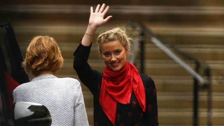 Actor Amber Heard waves as she leaves the High Court in London, Britain July 15, 2020. REUTERS/Hannah McKay
