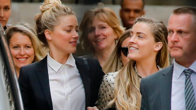 US actress Amber Heard (L) leaves hand-in-hand with her sister Whitney Heard (R) from the High Court after a hearing in the libel trial by her former husband US actor Johnny Depp against News Group Newspapers (NGN) in London, on July 24, 2020. - Depp is suing the publishers of The Sun and the author of the article for the claims that called him a "wife-beater" in April 2018. (Photo by Tolga AKMEN / AFP) (Photo by TOLGA AKMEN/AFP via Getty Images)
