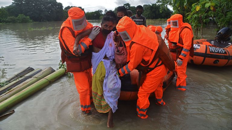 An unwell woman is rescued from the floods in Pathsala, Assam 