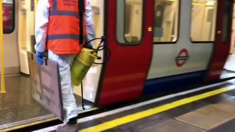 Banksy can be seen getting onto the Tube with a spray paint pump. Pic: Banksy