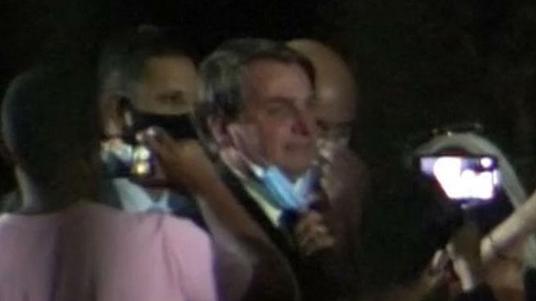 Bolsonaro greets supporters with mask down