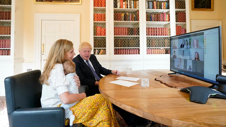 Boris Johnson and his partner Carrie Symonds with their son Wilfred speaking to midwives