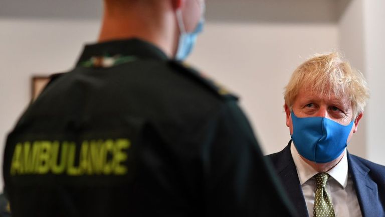 LONDON, UNITED KINGDOM - JULY 13: Britain&#39;s Prime Minister Boris Johnson (R), wearing a face mask or covering due to the COVID-19 pandemic, talks with a paramedic as he visits the headquarters of the London Ambulance Service NHS Trust on July 13, 2020 in London, England. (Photo by Ben Stansall-WPA Pool/Getty Images)
