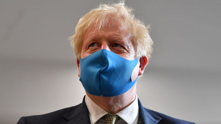 Boris Johnson, pictured here wearing a mask in London, has played down the prospect of a second national lockdown