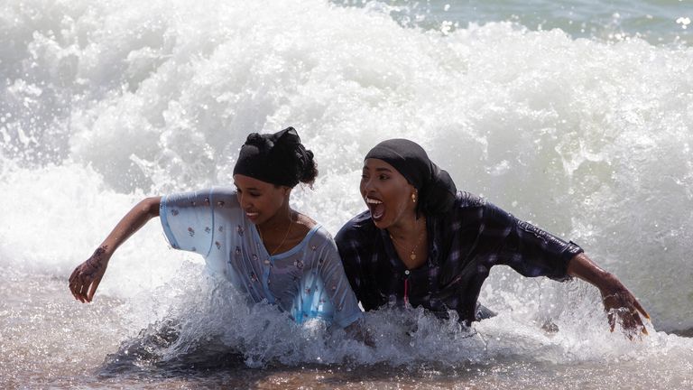 Some beachgoers headed into the ocean as temperatures soared in Brighton