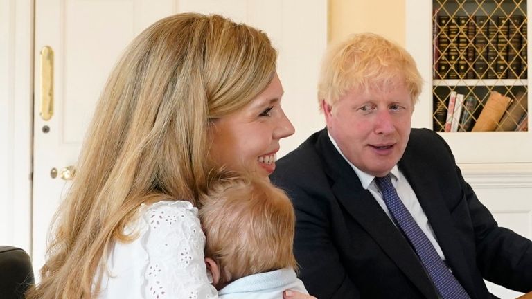 Boris Johnson and his partner Carrie Symonds speak to midwives