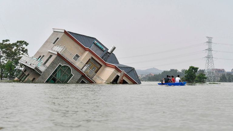 A house topples over due to the flooding in China&#39;s central Jiangxi province