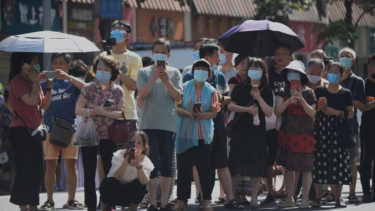 People stand on a road leading to the US consulate in Chengdu