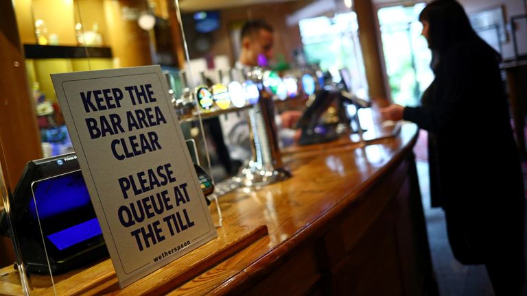A sign is pictured at The Holland Tringham Wetherspoons pub after it reopened following the outbreak of the coronavirus disease (COVID-19), in London, Britain July 4, 2020. REUTERS/Hannah McKay
