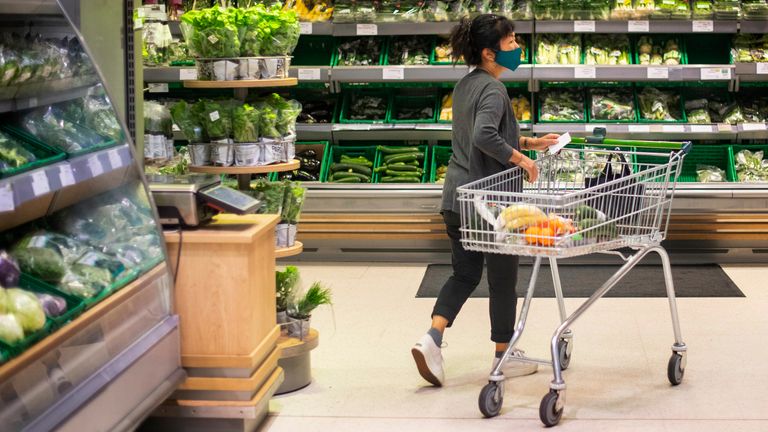 A shopper wearing a face mask in a supermarket in East London