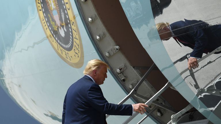 US President Donald Trump waves as he boards Air Force One prior to departure from Miami International Airport in Miami, Florida, July 10, 2020