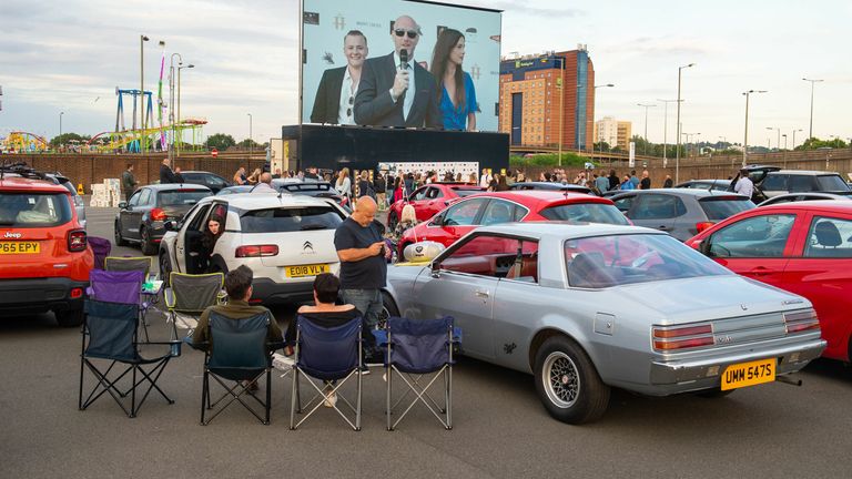 People watch the drive-in premiere of Break at the Brent Cross Drive-In at Brent Cross Shopping Centre in north west London 