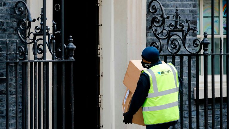 A Hermes courier delivers boxes to Number 10 Downing St during the lockdown in May