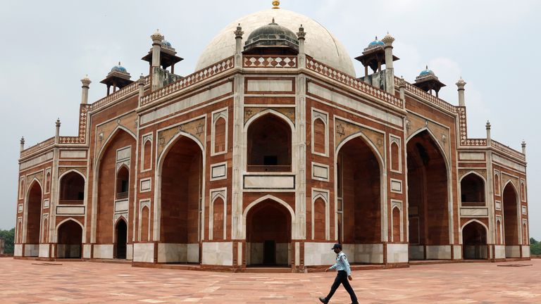 A security guard walks in front of Humayun's Tomb in New Delhi