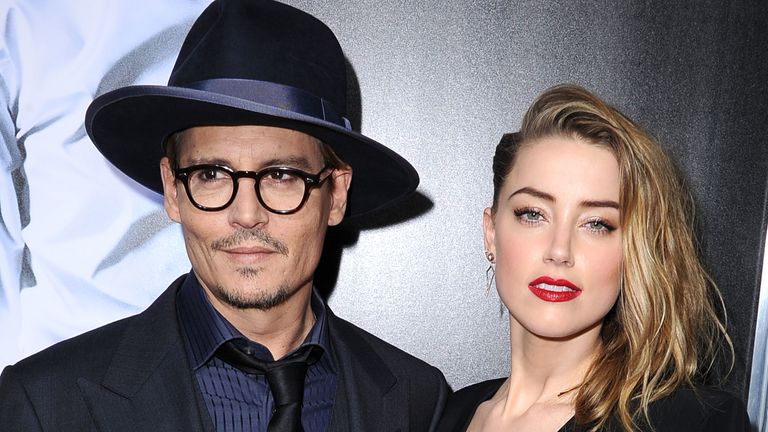 Johnny Depp and Amber Heard arrive at the "3 Days To Kill" at ArcLight Cinemas on February 12, 2014 in Hollywood, California.