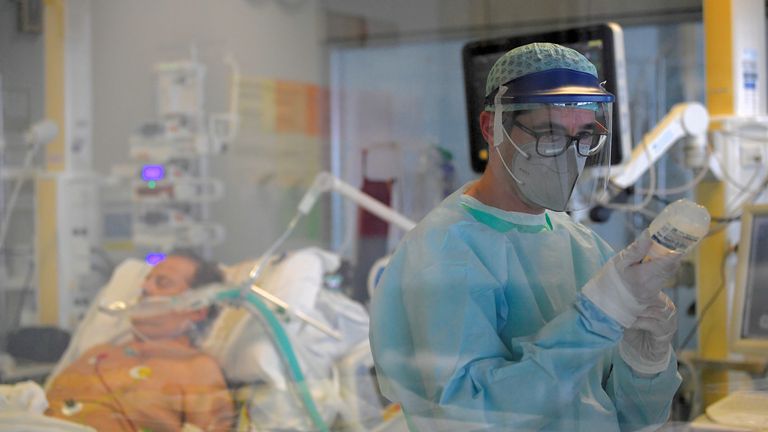A medical staff member is seen next to a patient suffering from the coronavirus disease (COVID-19) in the intensive care unit at the Papa Giovanni XXIII hospital in Bergamo, Italy May 12, 2020. Picture taken May 12, 2020. REUTERS/Flavio Lo Scalzo REFILE - CORRECTING NAME OF THE HOSPITAL