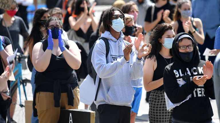 Protesters give a round of applause to celebrate the 72nd anniversary of the NHS at a gathering in support of the Black Lives Matter movement in London