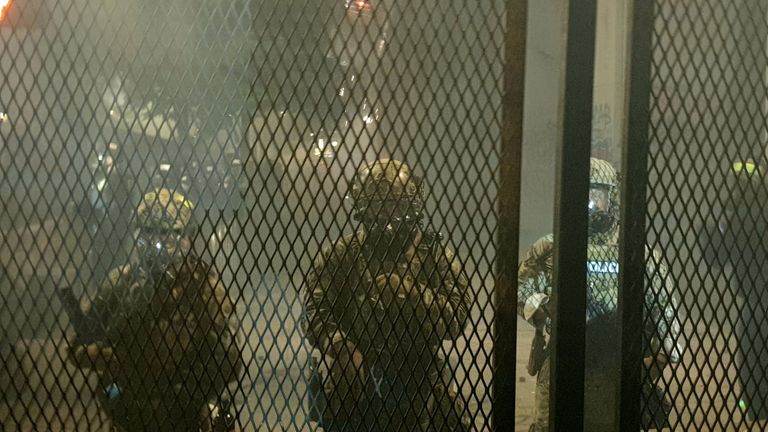 Federal officers put up a fence around Portland&#39;s courthouse but it was pulled down by protesters