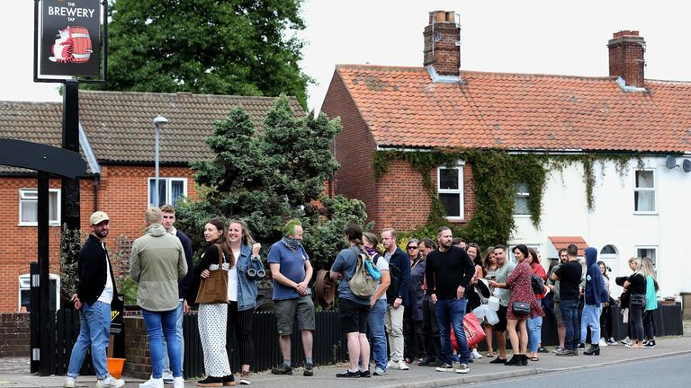 Customers queue outside the Fat Cat Brewery Tap pub in Norwich as lockdown restrictions are eased in England