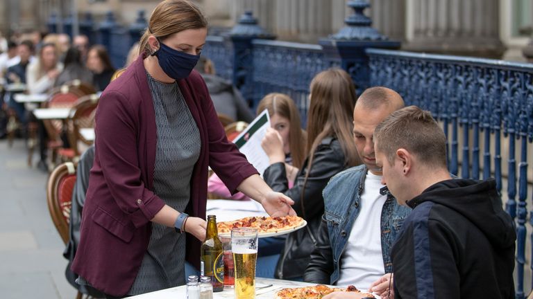 Meals are served on the street at Di Maggio&#39;s outdoor restaurant area in Glasgow city centre