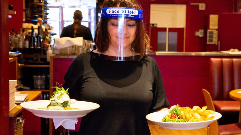 BRIGHTON, ENGLAND - JULY 04: A waitress serves food at Terre Terre, an exclusively vegetarian restaurant, on July 04, 2020 in Brighton, England